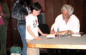 David Suzuki signing a book for a young fan